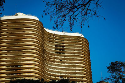 Low angle view of building against clear blue sky