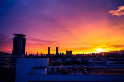 Silhouette of buildings against dramatic sky