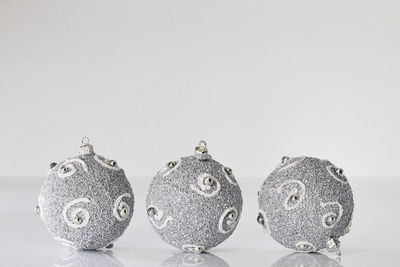 Close-up of decorations over white background