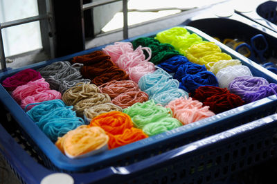 High angle view of multi colored wool in crate for sale