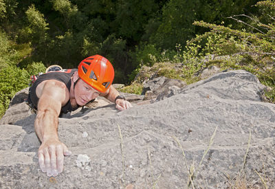 Man climbing limestone cliff in south wales