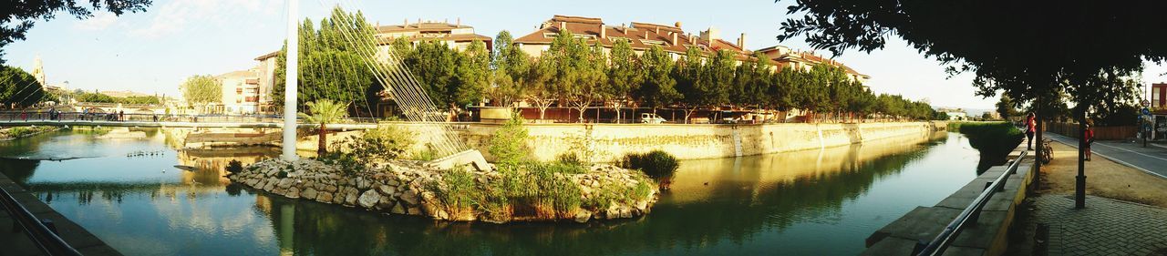 architecture, built structure, water, reflection, waterfront, building exterior, tree, river, connection, bridge - man made structure, clear sky, arch bridge, sky, bridge, outdoors, canal, no people, day, lake, nature