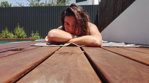 Close-up of young woman sitting on book