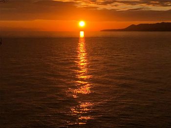 Scenic view of sea against romantic sky at sunset