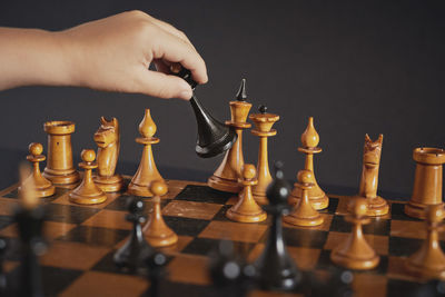 Midsection of person with candles on chess board