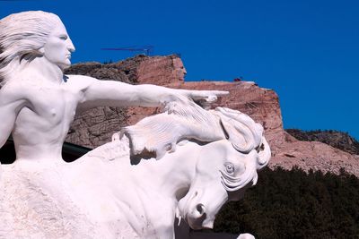 Statue against clear blue sky