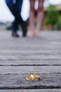 Close-up of rings with people standing on wooden floor in background