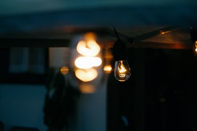 Illuminated lights seen through glass window at night