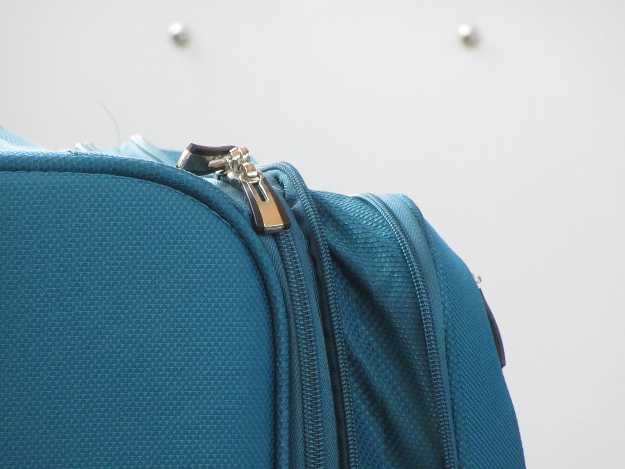 CLOSE-UP OF CLOTHES HANGING ON BLUE BACKGROUND