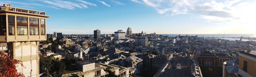 Panoramic view of city against cloudy sky