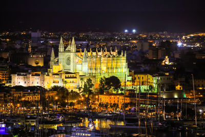 High angle view of illuminated buildings in city at night