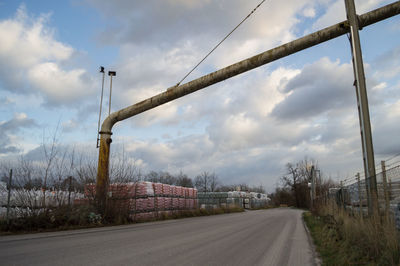 Street by road against sky in city