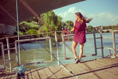Full length of woman standing in water