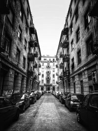 Street amidst buildings against sky in city