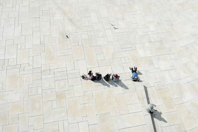High angle view of people relaxing on floor against building