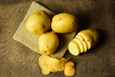 High angle view of potato and chips on burlap