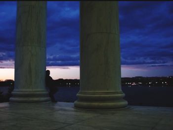 View of illuminated building against cloudy sky