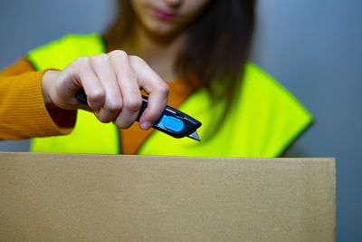 Midsection of woman holding mobile phone