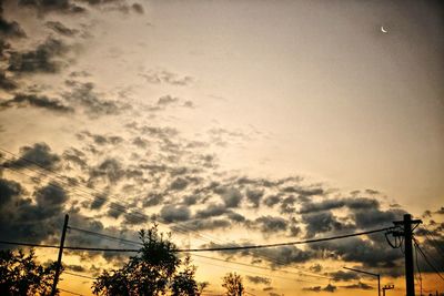 Low angle view of silhouette trees against sky