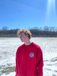 Portrait of young man standing on snow