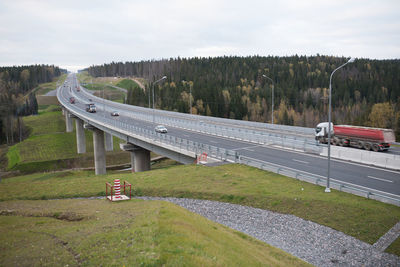 Bridge over field against sky