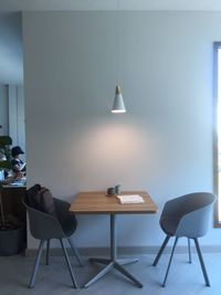 Table and chairs against wall at home