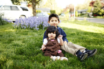 Portrait of father and daughter on grass