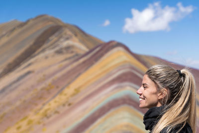 Low angle view of woman looking away against mountain