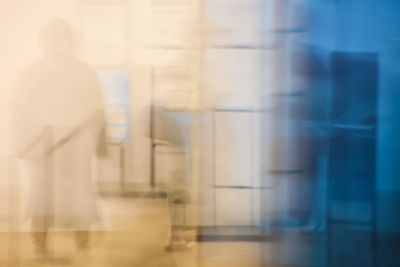 Rear view of woman standing by window