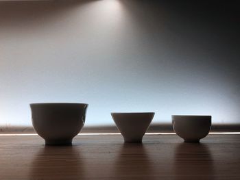 Close-up of tea on table against wall