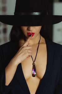 Close-up of woman wearing hat and necklace