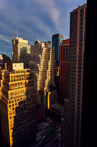 Aerial view of buildings in city against sky