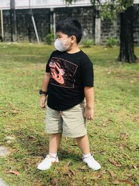 Rear view of woman standing on field