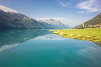 Scenic view of lake and mountains against sky