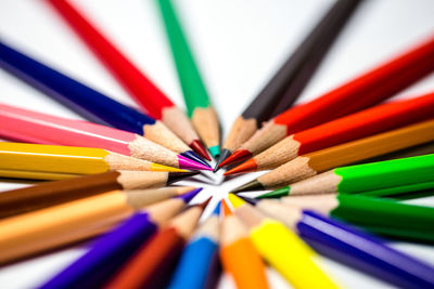 Close-up of colored pencils arranged on table