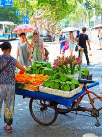 People at market stall in city