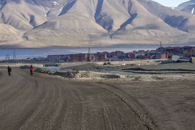 Man walking on beach against sky