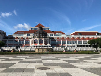 Buildings in city against blue sky