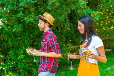 Young couple standing by drink