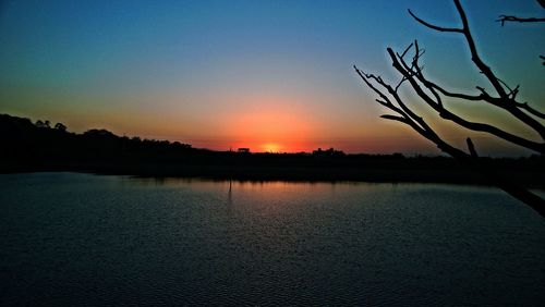 Scenic view of lake against sky during sunset