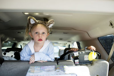 Portrait of girl wearing headband traveling in car