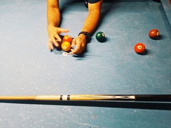 Cropped hand of person playing pool
