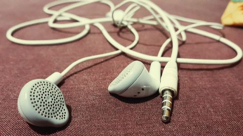 High angle view of in-ear headphones on table