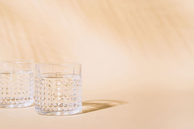 Close-up of glass of water against white background