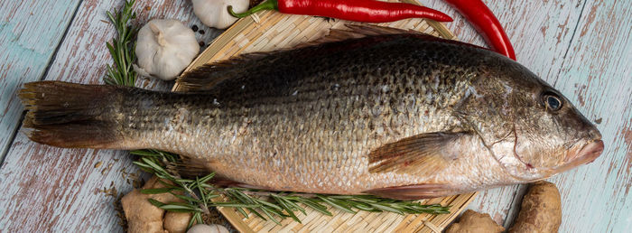 High angle view of fish on cutting board