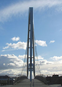 Low angle view of suspension bridge against sky