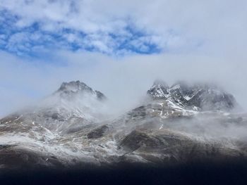 Scenic view of sea and mountains against sky