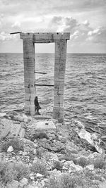 Man on beach by sea against sky