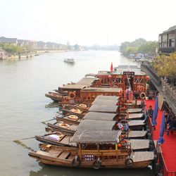 High angle view of harbor by river against sky