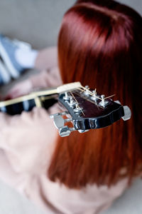 Close-up of woman playing guitar